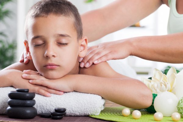 young boy  relaxing in spa. stone massage.